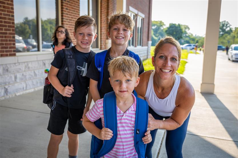 A family takes a photo on the first full day of kindergarten